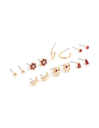Discover stud earrings in a 7-pack featuring butterfly, floral, heart, and ball designs with red diamante accents and gold finish front view - link has visual effect only