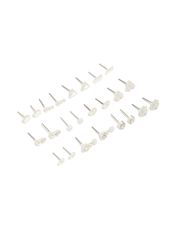 Showcasing a 12-pack of stud earrings featuring floral, triangle and pearl designs in silver and white front view