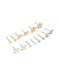 Discover a 7-pack of gold stud earrings featuring butterfly, ball and floral designs with pearl and enamel crafted from enamel front view - link has visual effect only