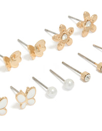 Featuring a 7-pack of gold stud earrings with butterfly, ball and floral designs pearl enamel close up view - link has visual effect only