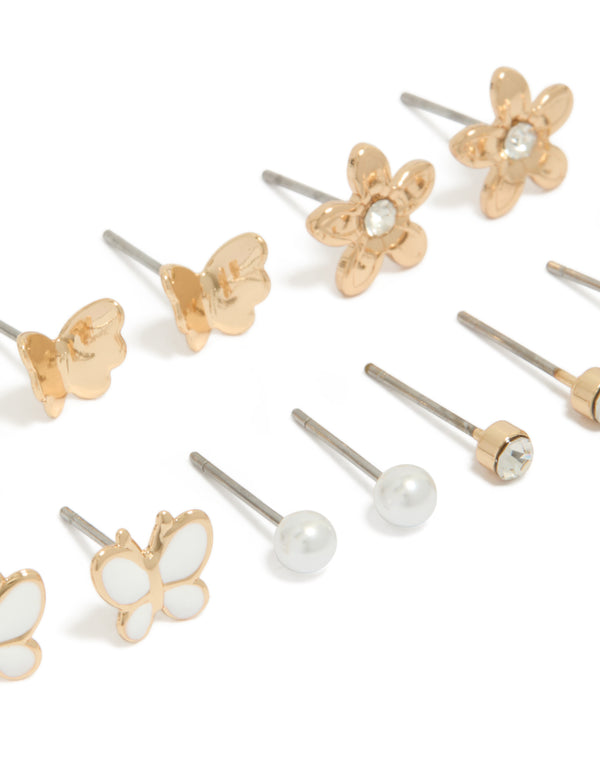 Featuring a 7-pack of gold stud earrings with butterfly, ball and floral designs pearl enamel close up view