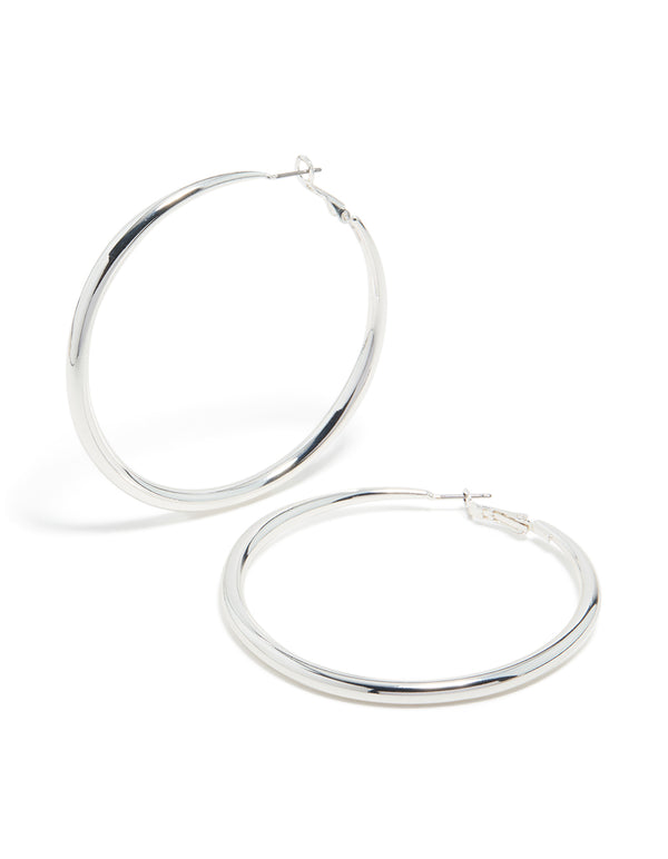 Featuring silver plated dome hoop earrings with closure in silver front view