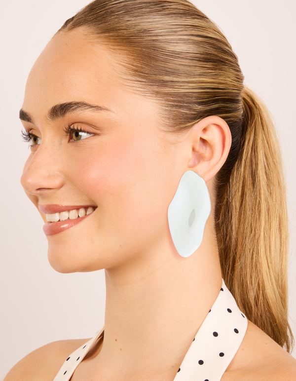 Crafted from silver plated material organic wrapped large oval earrings with chunky statement design on model view