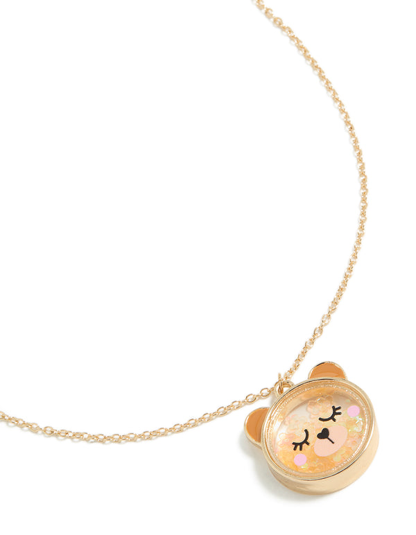 Showcasing a kids necklace with animal bear pendant in gold plated metal close up view