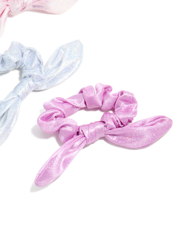 Crafted from polyester, these kids pastel bunny ear scrunchies in a 3-pack showcase glitter and solid print in lavender, light blue, and light pink side view