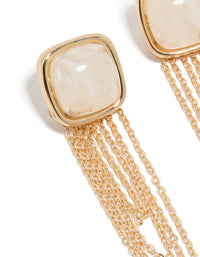Showcasing statement gold white stone and layered chain drop earrings close up view - link has visual effect only