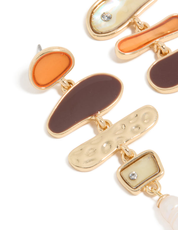 Featuring gold genuine shell and pearl mismatched drop earrings with charm ocean details close up view
