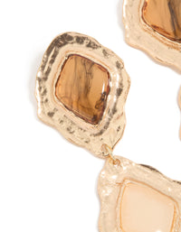 Showcasing textured metalwork, these gold molten Aztec drop earrings reveal statement styling in close up view - link has visual effect only