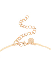 Featuring a beaded acrylic yarn necklace in cream and gold tones clasp detail view - link has visual effect only