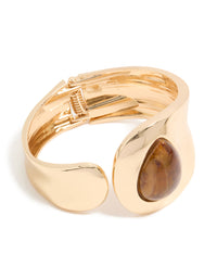 Introducing a gold teardrop brown stone wrist cuff in statement style front view - link has visual effect only