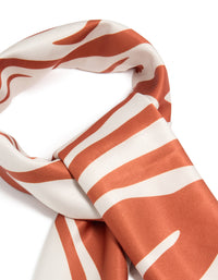 Elegantly designed white and orange lined fabric scarf with abstract print in coral and ivory detail view - link has visual effect only