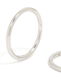 Displaying statement chunky surgical steel sleeper hoop earrings in silver close up view - link has visual effect only
