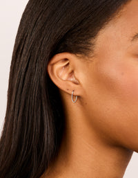 Showcasing fine surgical steel sleeper earrings in silver with hoop closure on ear view - link has visual effect only