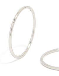 Highlighting surgical steel sleeper earrings in silver with hoop closure close up view - link has visual effect only