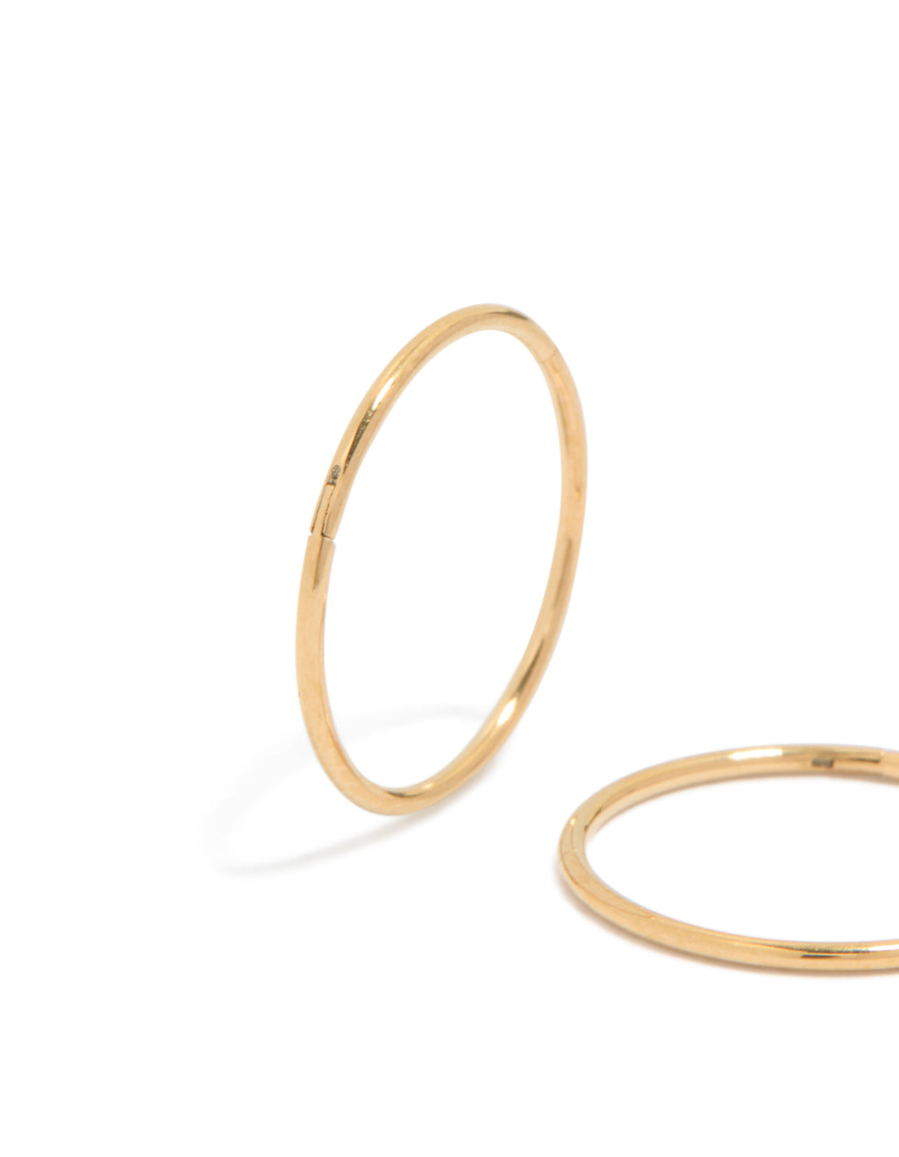 Highlighting 12 MM sleeper hoop earrings crafted from gold plated surgical steel in close up view