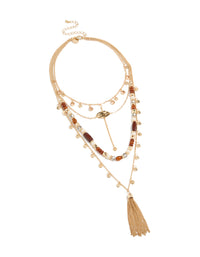 Elegant layered statement necklace featuring beads, tassel, charm and disc in gold front view - link has visual effect only