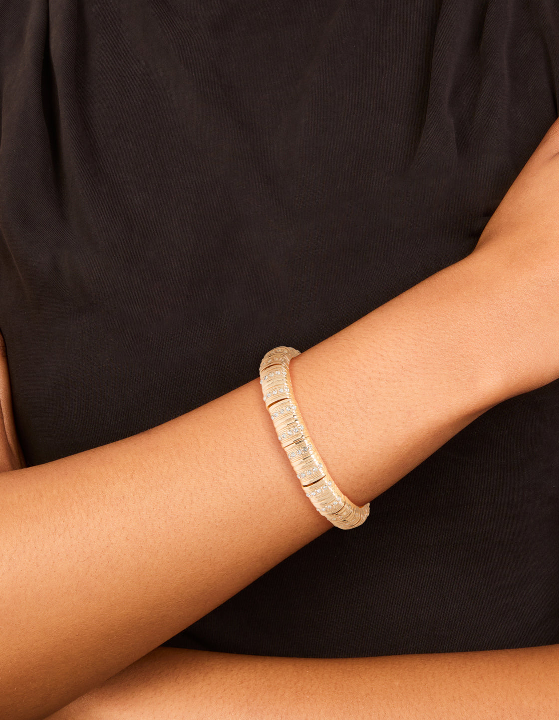 Elegant gold ribbed diamante stretch bracelet on wrist view