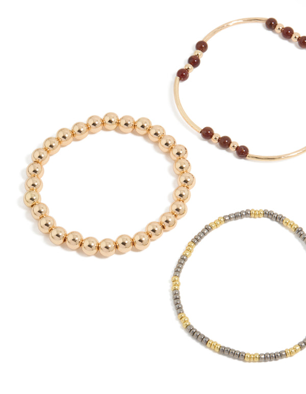 Featuring beaded stretch bracelets in blue, brown, gold, and ivory close up view