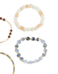 Featuring beaded stretch bracelets in blue, brown, gold, and ivory close up view - link has visual effect only