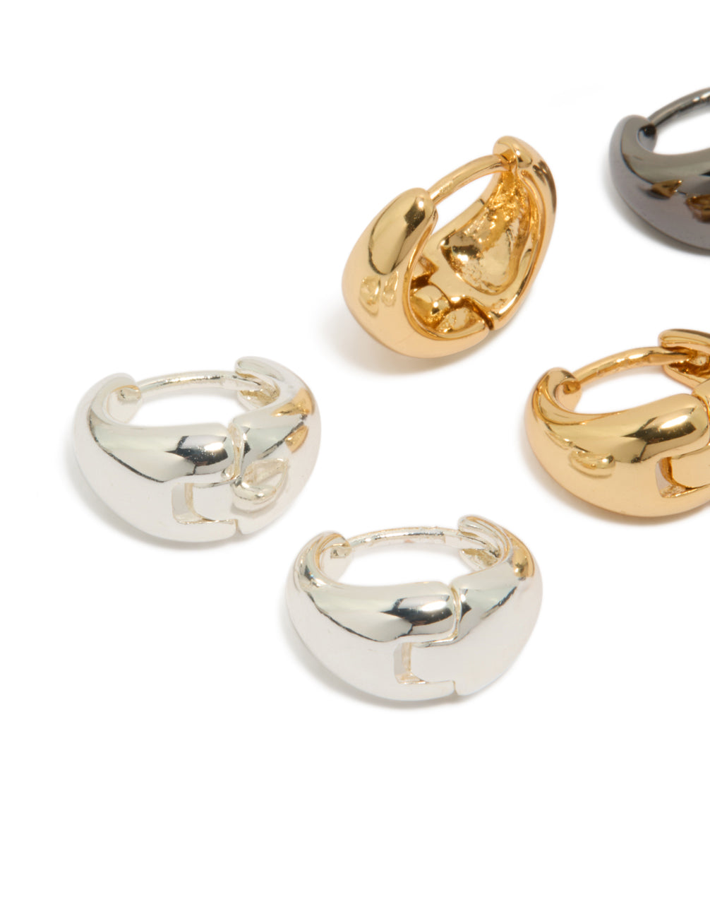 Displaying mixed metal small graduated huggie earrings in a 3-pack with silver plated and gold plated finishes close up view