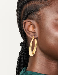 Crafted from gold plated material, thick thin hoop earrings with closure on ear view - link has visual effect only