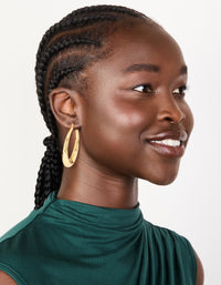 Featuring gold plated thick thin hoop earrings with closure on model view - link has visual effect only