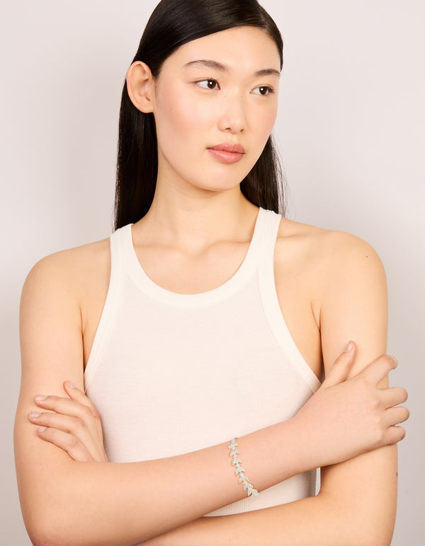 Featuring a silver plated cubic zirconia vine leaf toggle bracelet in a statement style on model view