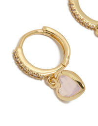Crafted from gold plated material, these dainty cubic zirconia and pink heart drop huggie earrings are presented in a close up view - link has visual effect only