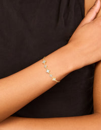 Stunning gold plated cubic zirconia and floral bracelet shown with toggle closure on wrist view - link has visual effect only