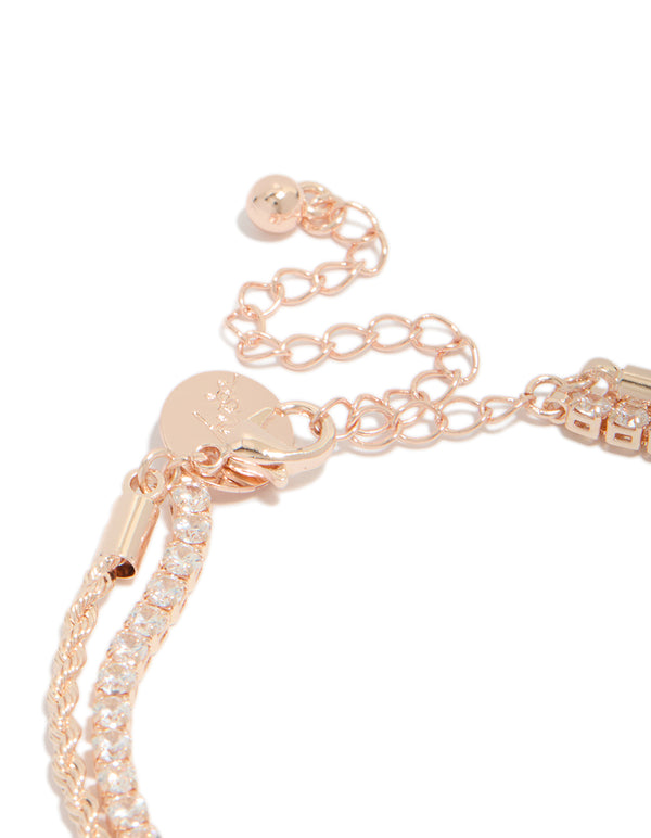 Featuring a rose gold plated cubic zirconia tennis and heart layered bracelet with charm detail closure detail view