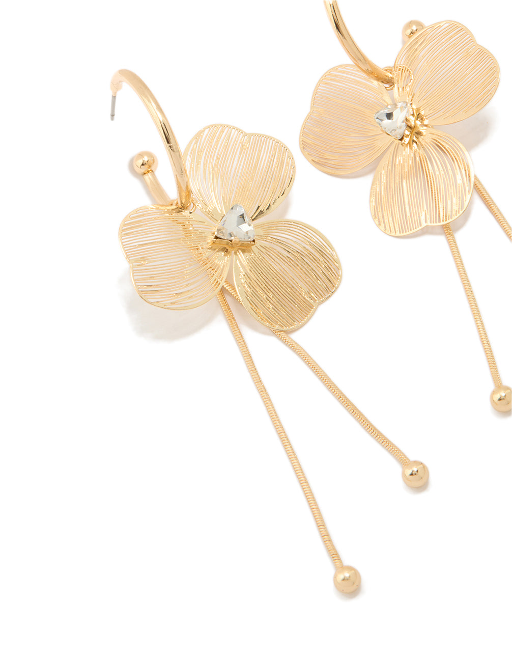 Featuring laser cut flower drop earrings in gold with floral and white gemstone center statement details close up view