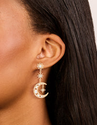 Showcasing gold pearl celestial drop earrings with charm accents on ear view - link has visual effect only
