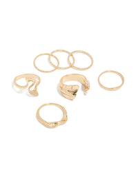 Showcasing gold dainty organic rings in a 7-pack front view - link has visual effect only