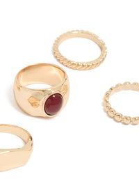 Featuring gold chunky rings in a 5-pack with maroon stone centerpiece, and statement styling close up view - link has visual effect only