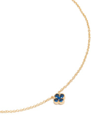 Showcasing a floral pendant with sapphire stones, crafted from gold plated material in a dainty style close up view - link has visual effect only