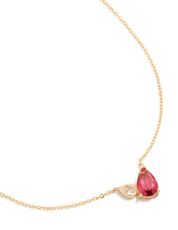 Featuring a gold plated pendant necklace with red cubic zirconia crystal close up view - link has visual effect only