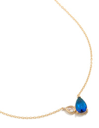 Showcasing a gold plated September blue cubic zirconia pendant necklace featuring crystal and dainty design close up view - link has visual effect only