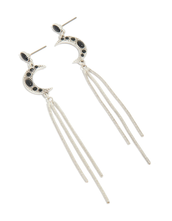 Showcasing dainty silver drop earrings featuring celestial moon with black gemstone accents and tassel chain detailing front view