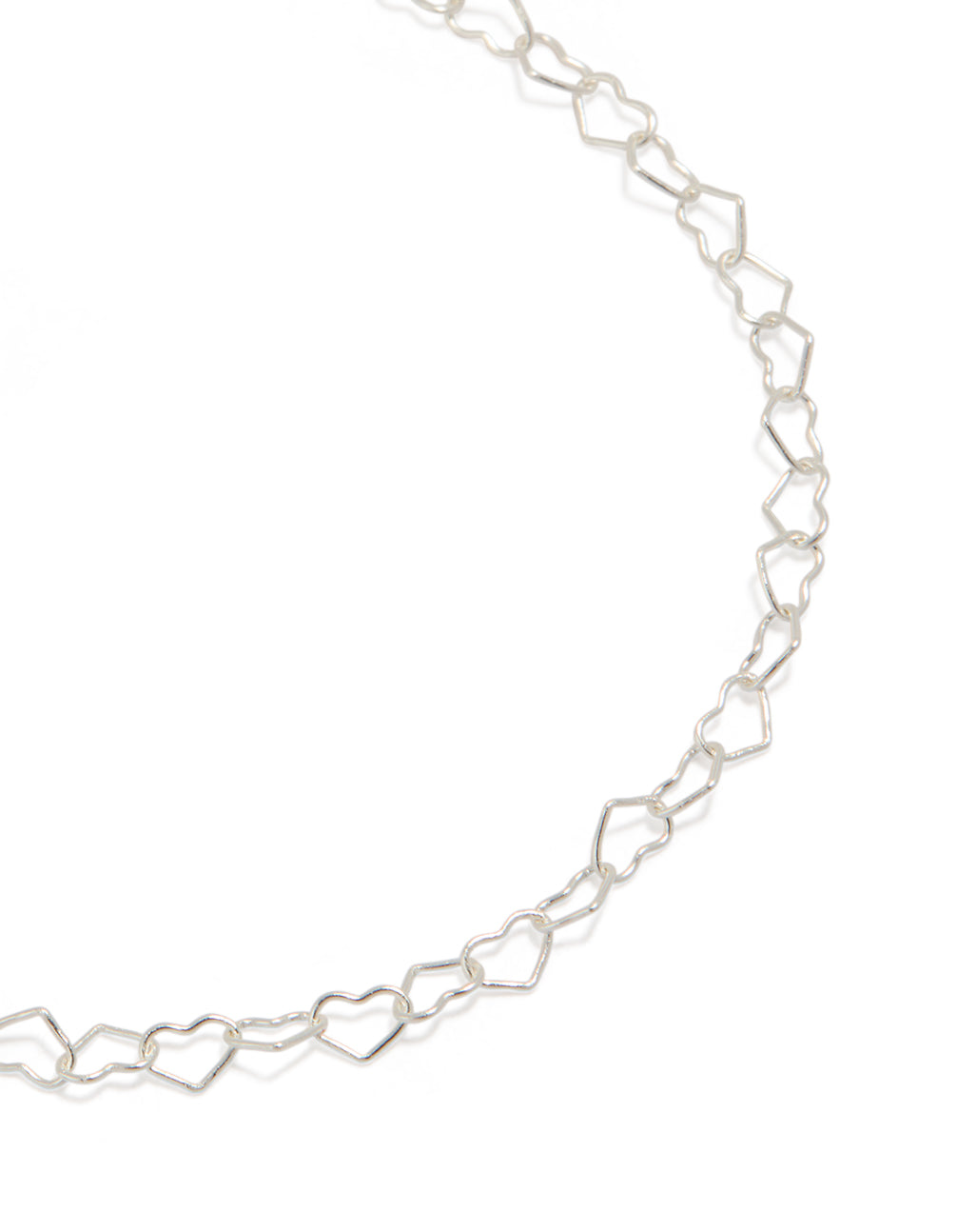 Showcasing sterling silver heart link bracelet in a close up view