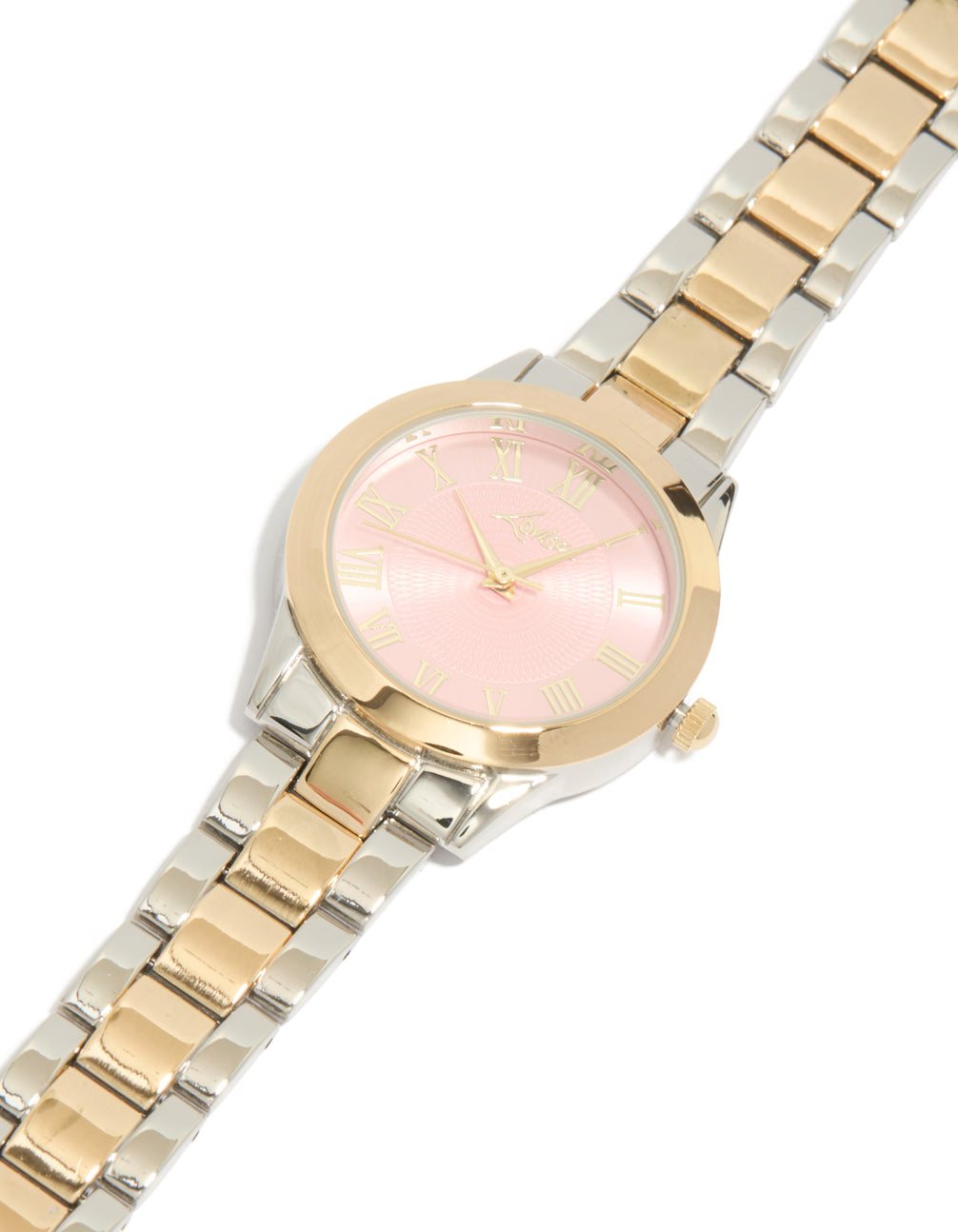 Showcasing a mixed metal pink face roman numeral watch with numbers on a round dial, designed for women in casual settings, featuring a multi-color link band and analog type watch face detail view
