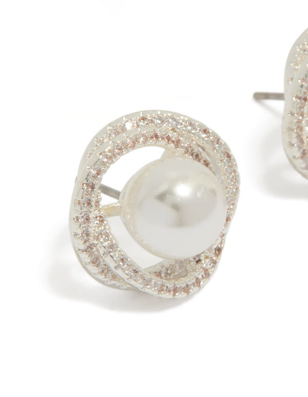 Crafted from silver plated metal, these cubic zirconia and pearl twist stud earrings are shown in close up view