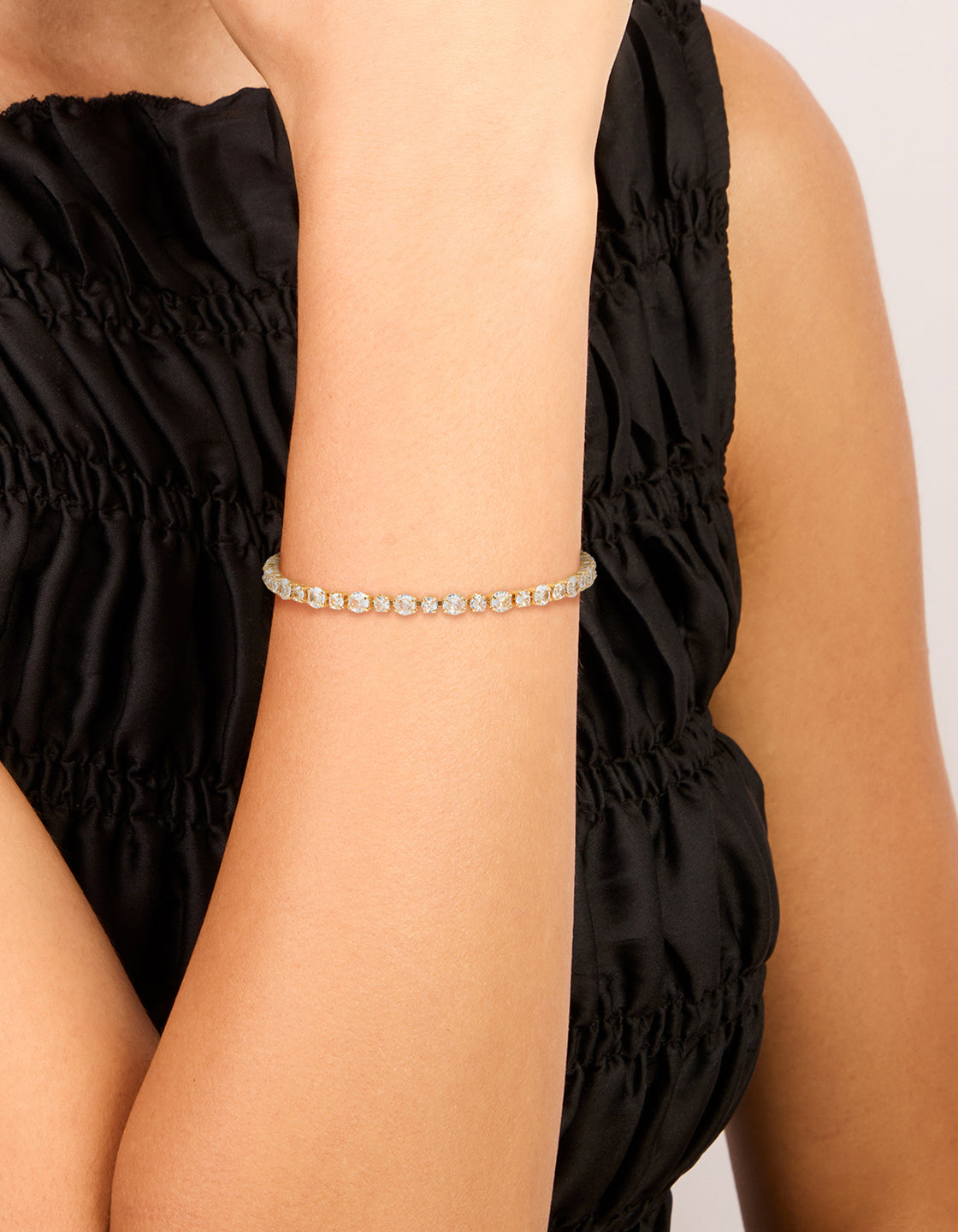 Featuring a gold plated large square cut cubic zirconia tennis bracelet on wrist view