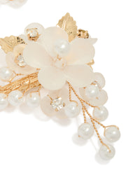 Crafted from gold plated material, this pearl and acrylic flower clip with leaf and floral details in ivory and white detail view - link has visual effect only