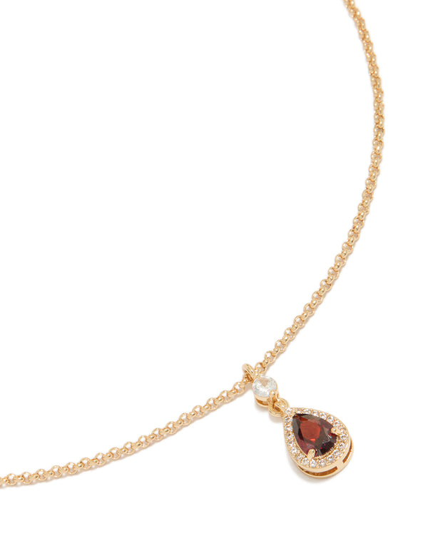 Showcasing a gold red pear cubic zirconia pendant necklace with statement styling close up view