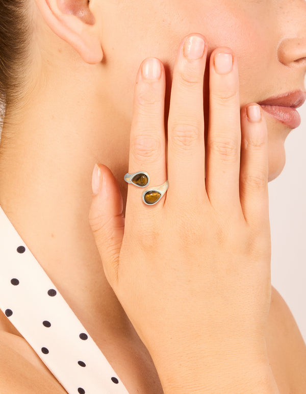 Showcasing a waterproof stainless steel ring with double tigers eye stones in silver tones on finger view