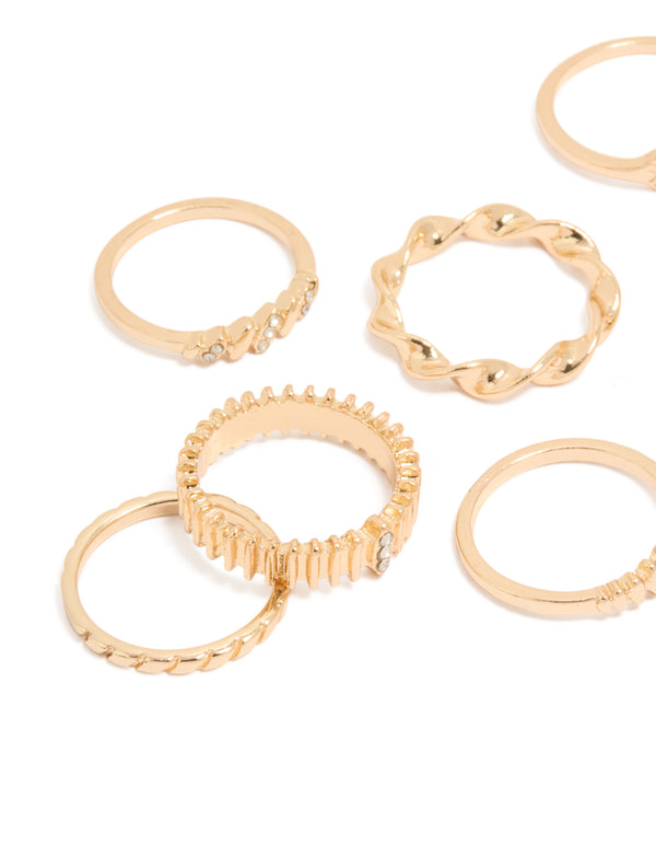 Crafted with a ten-pack of gold signet and ribbed statement rings featuring celestial star details close up view