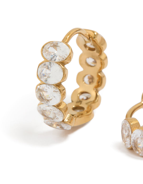 Explore waterproof huggie earrings crafted from gold plated stainless steel featuring round bezel set cubic zirconias in clear close up view