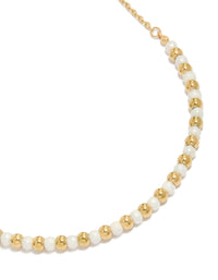 Elegant waterproof beaded necklace featuring alternating gold plated stainless steel balls and pearl close up view - link has visual effect only