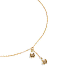 Showcasing a waterproof forget-me-not charm necklace in gold plated stainless steel close up view - link has visual effect only
