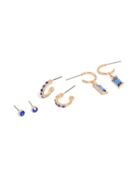 Featuring dark blue diamante studs and drop earrings in a 3-pack with baguette stone cut, huggie, hoop, and stud closures, crafted in gold front view - link has visual effect only